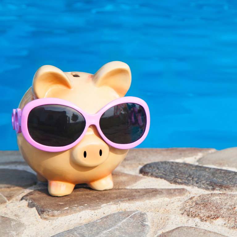 piggy bank with shades by a pool