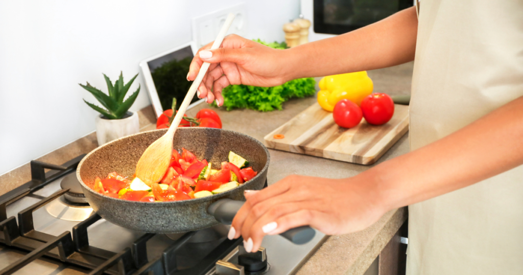 person cooking meal on a stove