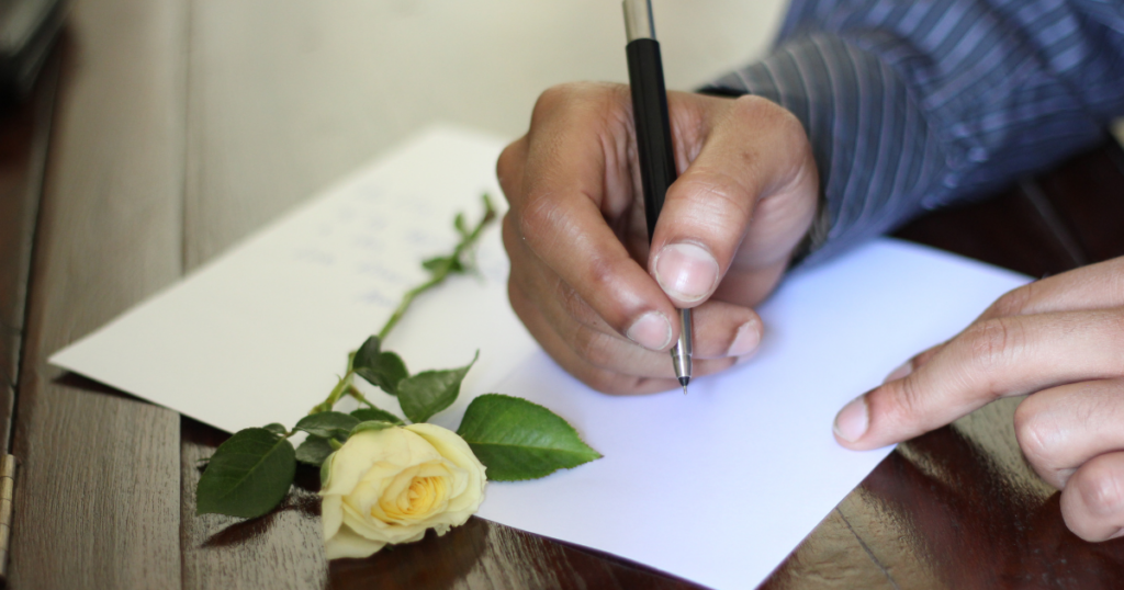 hands writing a love letter