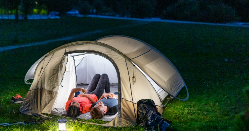 couple in a tent stargazing